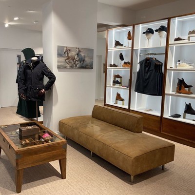 Freestanding Seat in brown suede leather within shoe store