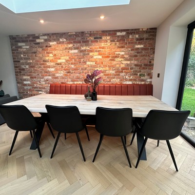 Fluted back banquette in leather against natural wall
